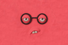 Nerd Monster With Glasses, Fabulous Creature Made By Hand From Pink Plasticine. Comic Facial Expressions. Ugly And Crazy Face Of Alien Monster. 3d Artwork