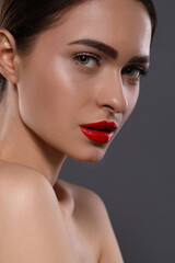 Sticker - Young woman with red lips makeup on grey background