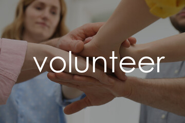 Wall Mural - Group of volunteers putting hands together indoors, closeup