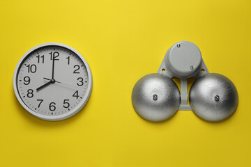Wall Mural - Modern electrical school bell and clock on yellow wall