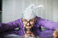 Bearded Funny Man In A Cap Of Aluminum Foil. Concept Art Phobias.Conspiracy Theory. Conspiracy. Insanity.