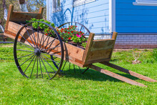 Vintage Wooden Cart With Flower Pots Stands In A Garden
