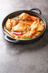 Canvas Print - Chicken with rhubarb, onions and garlic are simmered with white wine and butter into a rich sauce close-up in a frying pan on the table. vertical