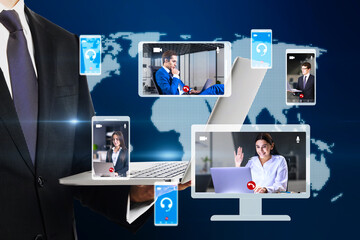 Poster - businessman hand holding laptop with creative globe map with computer screens and creative video conference call between attractive young european businesspeople. Blurry background. 