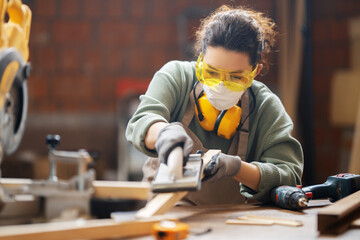 Canvas Print - woman carpenter in workshop