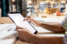 Hands Of Worker Using Tablet PC For Checking Inventory Working In Warehouse