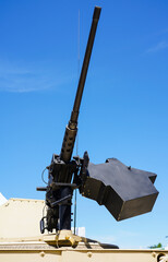 Military or army tank ready to attack and moving over a deserted battle field terrain.