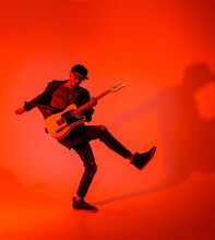 The Young Guitarist Emotionally Plays The Electric Guitar And Jumps On A Red Light