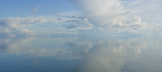 Wall Mural - sky and water. a calm landscape of clouds reflecting in the water