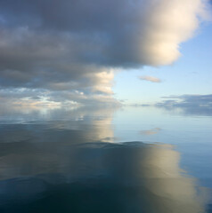 Wall Mural - sky and water. a calm landscape of clouds reflecting in the water