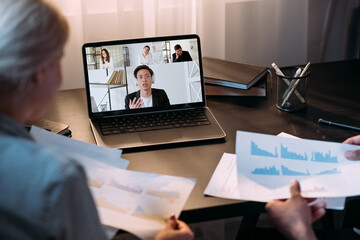 Canvas Print - Web meeting. International video chat. Corporate telework. Diverse business team using laptop working from home with colleagues on screen in virtual office.