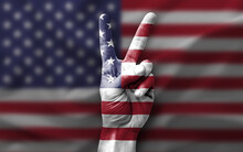 Hand Making The V Victory Sign With Flag Of Usa