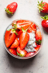 Wall Mural - Homemade chia pudding with strawberry in jar, gray background.