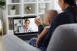 © Nattakorn - Asian mother with her baby making video call, talking with pediatrician doctor via computer laptop, Telehealth and Telemedicine concept