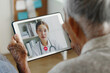 © Nattakorn - Asian senior woman grey hair 80-90s video call with doctor, telemedicine telehealth concept