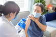 © Tom Wang - Senior woman receiving vaccine. Medical doctor vaccinating an elderly patient against flu, covid-19, pneumonia or coronavirus.