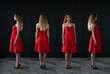 © vadim_fl - portrait of a beautiful young woman in a red dress, studio shot on a dark background
