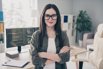 Poster - Portrait of attractive cheery content skilled girl expert folded arms at workplace workstation indoors