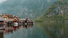 Wooden Boathouses Forming The Waterfront Of Hallstatt