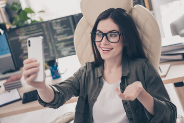 Poster - Portrait of attractive cheerful skilled girl web developer taking selfie calling video app communication at workplace workstation indoors