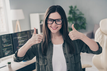 Canvas Print - Portrait of beautiful cheerful content girl expert showing double thumbup advert at workplace workstation indoors