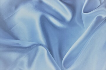light blue pearl silk gathered in folds. satin or some other noble material.