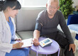 © Tom Wang - Asian caregiver doctor examine older patient use blood pressure gauge.