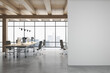 © Who is Danny - Front view on blank grey wall in light eco style office with stylish workspaces, modern computers, glossy concrete floor, wooden ceiling and city view from big window. 3D rendering, mock up