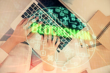 Poster - Double exposure of woman hands working on computer and blockchain theme hologram drawing. Top View. bitcoin cryptocurrency concept.