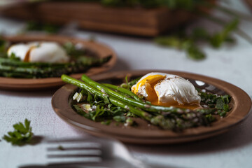 Wall Mural - Healthy breakfast with asparagus and  poached egg on rustic table