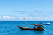 Traditional Sailing Dhow  At Anchor On The Blue Ocean