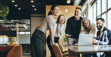 Happy Businesspeople Laughing In An Office