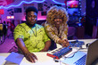 © AnnaStills - Young Gen Z African American man and woman wearing fashionable casual clothes working together on music album in home recording studio looking at camera
