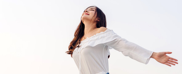 Smiling of cheerful beautiful pretty asian woman standing stretch her arms relax and enjoy with nature fresh air.asia beauty