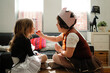 © Austockphoto - Two girls dressed as princesses playing putting on makeup