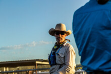 Cowboy Facing Camera, Talking To A Cowgirl.