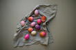 © Austockphoto - colourful Easter eggs on grey fabric