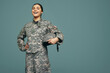 © Jacob Lund - Cheerful female soldier smiling in a studio