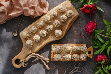 Handmade sweets candies on a wooden boards for dessert and treat. Homemade chocolate sweets with a flowers. Top view