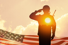 Silhouette Of Soldier With Print Of Sunset Saluting On A Background Of USA Flag And Sky. Greeting Card For Veterans Day, Memorial Day, Independence Day. America Celebration. Closeup. 3D-rendering.