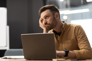 Poster - Unhappy Businessman Sitting Near Laptop Computer Having Problems In Office