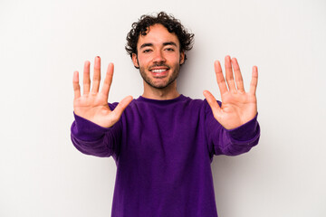 Young caucasian man isolated on white background showing number ten with hands.