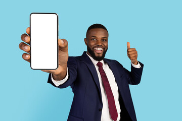 Cheerful African American Businessman Holding Big Blank Smartphone And Showing Thumb Up