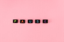 Pause Button Concept. Black Beads On Trendy Pink Background Making Word. Lifestyle Phrase Made Of Small Letters Symbolizing Relax And Keep Calm
