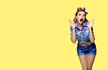 Wall Mural - WOW! Unbelievable breaking news! Excited surprised, very happy red purple haired woman. Pin up girl with open mouth and raised hands. Retro and vintage concept. Yellow background with copy space.