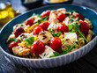 Roasted chicken nuggets, cherry tomatoes, feta cheese and fusilli  served on wooden table
