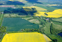 Aerial View Of The Skyline Of Oxfordshire Farmland With Oil Seed Rape Crop In Fields