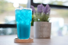 Refreshing Cold Beverage For Summer On Ice. Colorful Summer Drink In Tall Glass With Wood Saucer For Hot Day And Party.