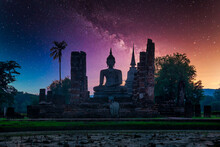 Milky Way Over Big Buddha At Night In Wat Mahathat Temple, Sukhothai Historical Park, Thailand.