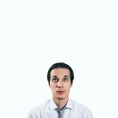 Poster - Man looking up in white shirt and tie isolated on blank light background with empty space for your text or logo, mockup. Thinking and brainstorming concept, close up